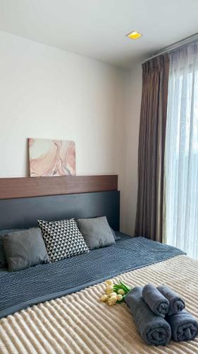 a bedroom with a bed with towels on it at The Astra Luxury Condo near old town in Chiang Mai