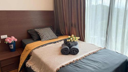a bed with two stuffed animals on top of it at The Astra Luxury Condo near old town in Chiang Mai