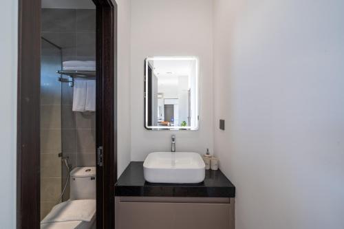 a bathroom with a sink and a mirror at Sam Hotel & Apartment Da Nang in Da Nang