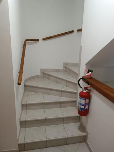 a staircase with a fire hydrantacistacistacistacist at B&B "LE LUCI" CAMERA IN ATTICO SUPER VISTA interno 2 rose rosa in Vasto