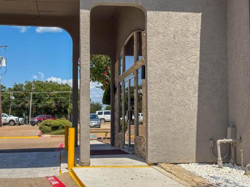 an entrance to a building with an open door at Studio 6 Suites Mesquite, TX – Gross Rd. in Mesquite