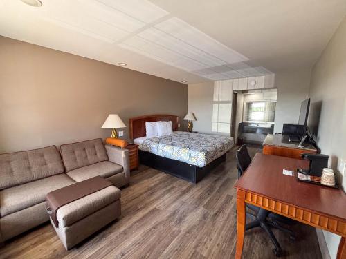 a hotel room with a bed and a desk at Studio 6 Suites Mesquite, TX – Gross Rd. in Mesquite
