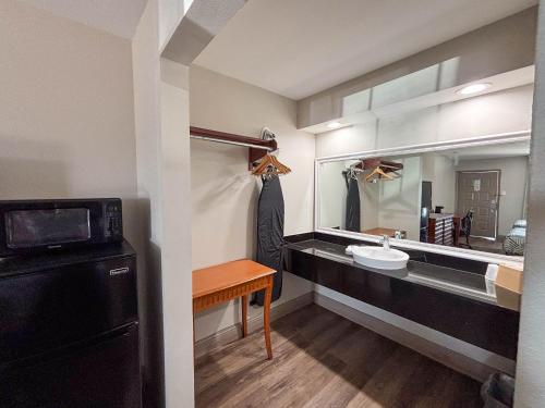a bathroom with a sink and a mirror at Studio 6 Suites Mesquite, TX – Gross Rd. in Mesquite