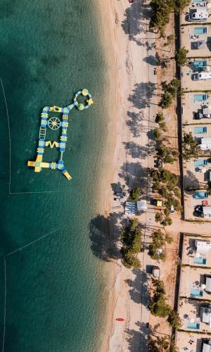 an aerial view of a beach with a dock at Aminess Style Glamping Villas & Holiday Homes Avalona in Povljana