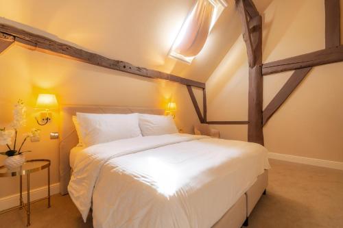 a bedroom with a large white bed in a room at Château de Looz in Borgloon