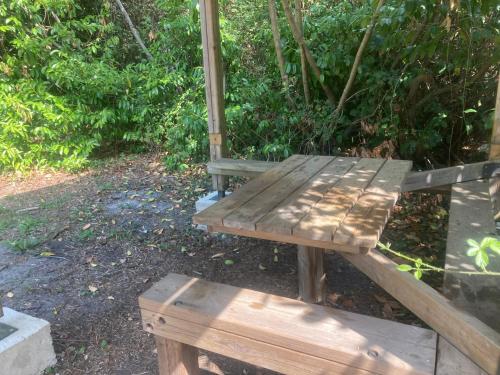 a wooden bench sitting on the ground in a park at campetoile in Montendre