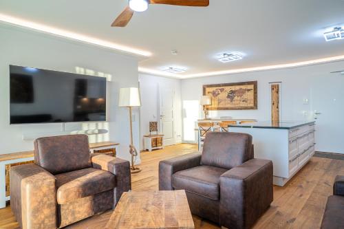 TV a/nebo společenská místnost v ubytování Dünenblick Premium-Apartments