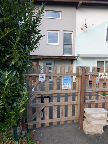 a wooden fence in front of a house at Mini Loft 30 - Apartment 3 