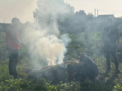 a group of people standing around a bonfire at Casa olivar de Riudoms in Reus