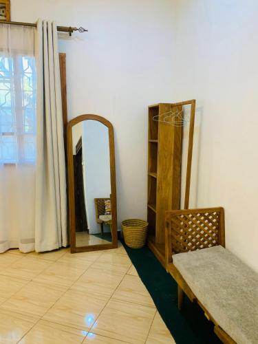 a room with a mirror and a bench next to a mirror at Mkoani Homestay in Moshi