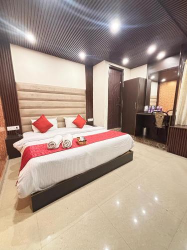 a bedroom with a large bed with red pillows at Lords Grey near Mall Road in Shimla