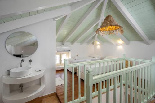 a bathroom with a sink and a mirror at Villa Theoni in Halki
