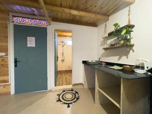 a kitchen with a counter and a door with a window at Tranquilo Boutique Hostel - Dahab in Dahab