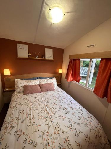 a bedroom with a bed and a window at Withernsea sands-Maple grove in Waxholme