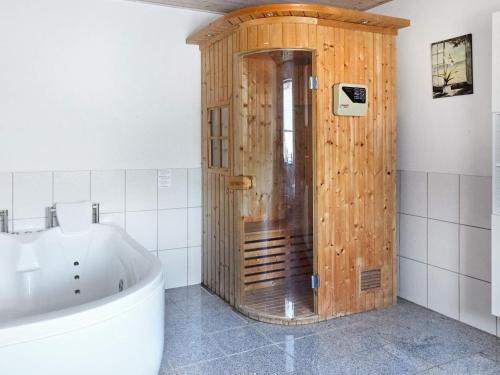 a wooden shower in a bathroom with a tub at 6 person holiday home in Asnæs-By Traum in Asnæs