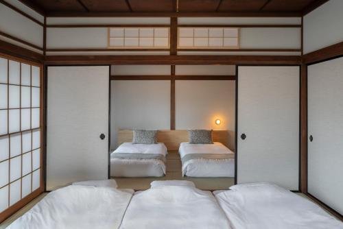 a bedroom with two beds in a room at YAMO Nagiso in Nagiso