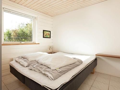 a large bed in a room with a window at 6 person holiday home in Asnæs-By Traum in Asnæs