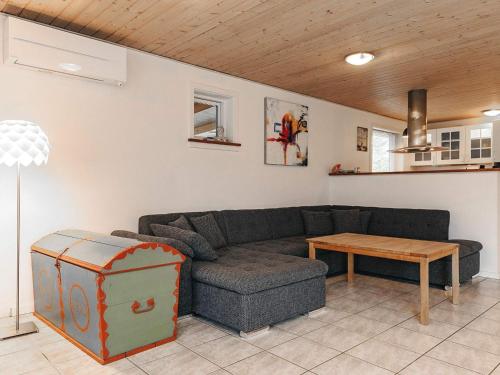 a living room with a couch and a table at 6 person holiday home in Asnæs-By Traum in Asnæs