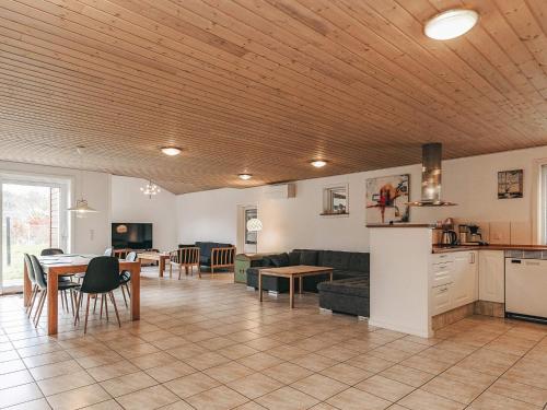 a living room with a couch and a table at 6 person holiday home in Asnæs-By Traum in Asnæs