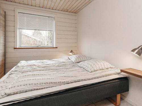 a bed in a white room with a window at 6 person holiday home in Asnæs-By Traum in Asnæs
