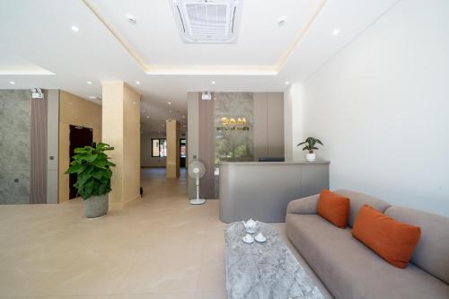 a living room with a couch and a table at Sam Hotel & Apartment Da Nang in Da Nang