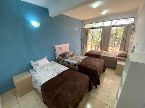 a room with three beds and a window at Departamento en alquiler in Cambyretá