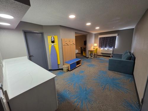 a living room with a couch and a room with snowflake carpet at Days Inn by Wyndham Waukegan in Waukegan