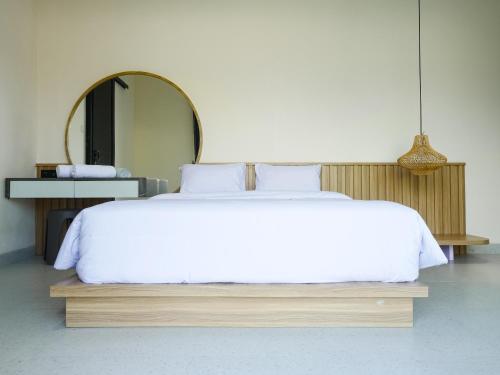 a bedroom with a large bed with a large mirror at Theolive Arrea - Spacious Private Pool and Backyard in Warung Menteng