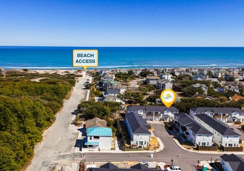 an overhead view of a town with a beach access sign at BCW32A - Sea Escape in Corolla