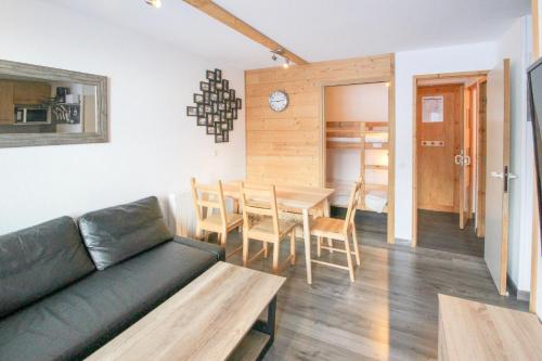 un soggiorno con un divano e un tavolo di Val Thorens - Appartements Ski aux Pieds au Cœur des Pistes a La Celle-sous-Gouzon