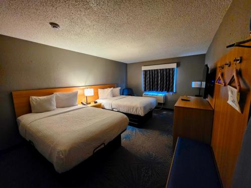 a hotel room with two beds and a window at Days Inn by Wyndham Waukegan in Waukegan