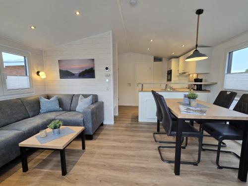 a living room with a couch and a table at Ostseeferienpark Walkyrien - Lotse j in Kagelbusch