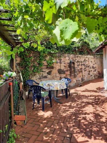 a table and chairs sitting on a brick patio at Ferienhaus in Gera