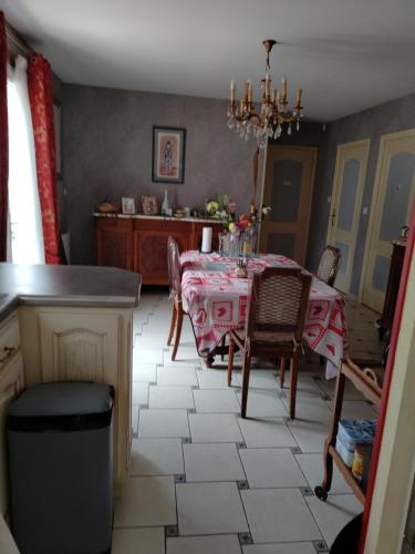 a kitchen with a table and chairs and a dining room at Appartement 3 pièces in Cloyes-sur-le-Loir