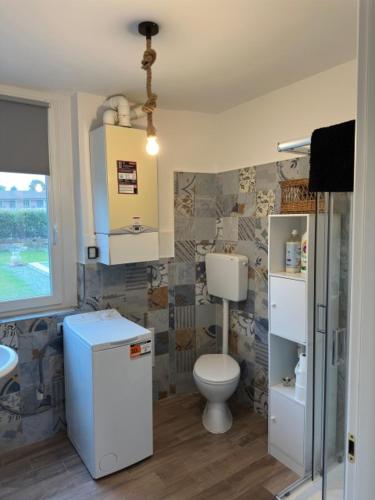 a bathroom with a toilet and a sink at La Casa di Manu in Lessona