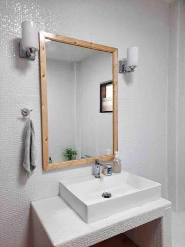 a bathroom with a white sink and a mirror at Mi Casa Pool Villa Hua Hin in Hua Hin