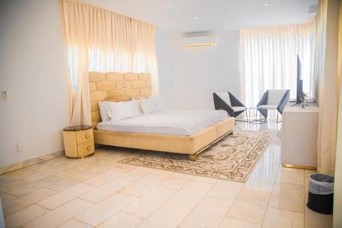 a bedroom with a bed and a table and chairs at ChristMindLimitedCompany in Accra