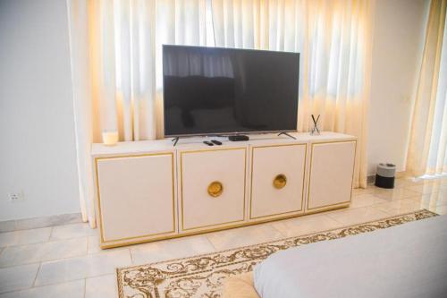 a entertainment center with a television on top of it at ChristMindLimitedCompany in Accra