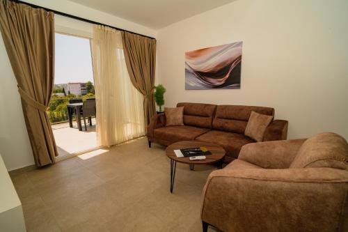 a living room with a couch and a table at Crown Salamis Hotel in Mağusa