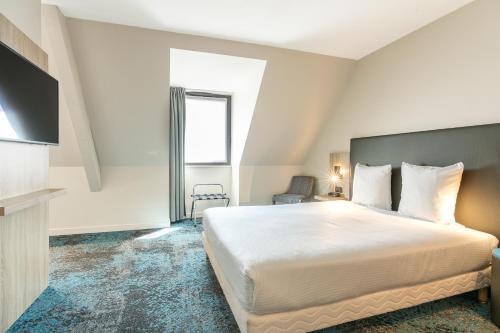 Letto o letti in una camera di Hôtel Maison Turenne