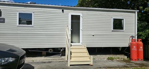 a ladder leading to the door of a mobile home at Lakeland leisure park sleeps up to 8 in Cark
