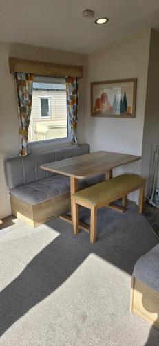 a living room with a table and a couch at Lakeland leisure park sleeps up to 8 in Cark