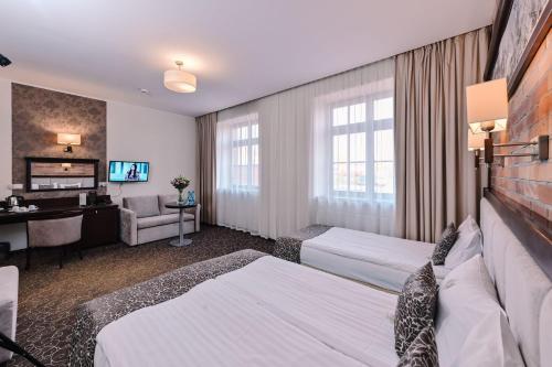 Postel nebo postele na pokoji v ubytování Hotel Zamek Gniew