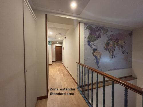 a hallway with a map of the world on the wall at Pensión Begoña - centro ciudad in Bilbao