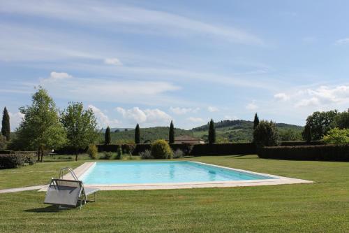 a swimming pool in the middle of a yard at Country Home Tuscany - Courtyard Room in Lano