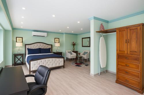 a bedroom with a bed and a desk and a chair at P V near Colomitos Beach Boutique Hotel in Puerto Vallarta