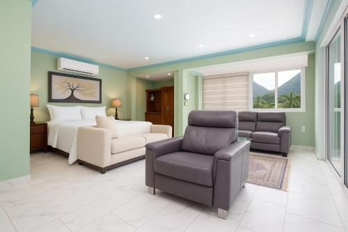 a living room with a bed and a couch and chairs at P V near Colomitos Beach Boutique Hotel in Puerto Vallarta