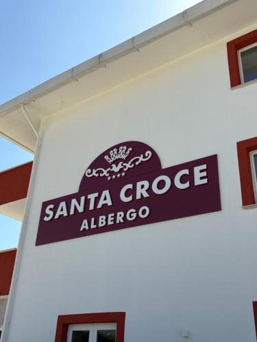 a sign on the side of a santa cruz alberoco gas station at Albergo Santa Croce in Giffoni Sei Casali