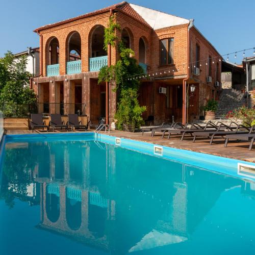 a large swimming pool in front of a building at Dimitris Cabin In surami in Surami
