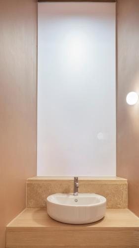 a bathroom with a sink and a mirror at Medieval Knights house GF with Seaview at the Three Cities Marina in Senglea